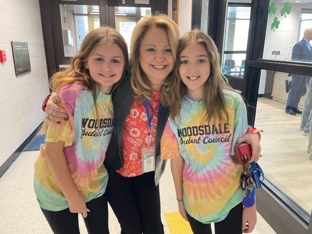Dr. Miller is shown with students at Woodsdale Elementary School