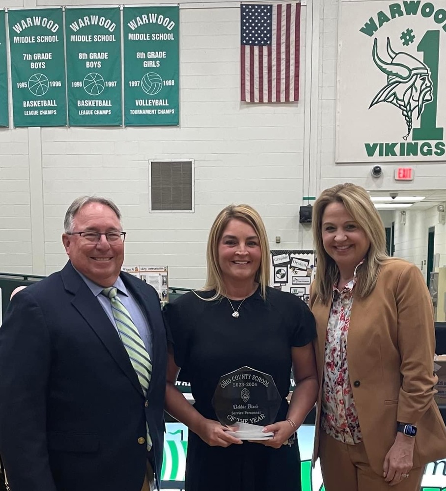 Ohio County Schools Service Personnel Employee of the Year Debbie Black is pictured with Board of Education President Andy Garber and Superintendent Kimberly Miller