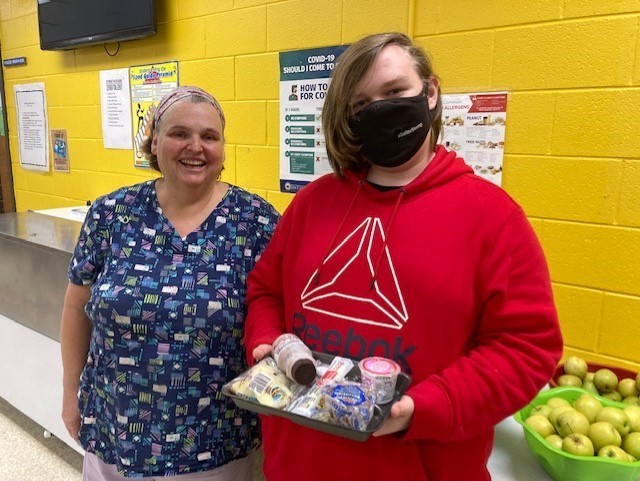 Pictured is Wheeling Middle School cook Jill Hutchison with Wildcat eighth grader Damian Roller