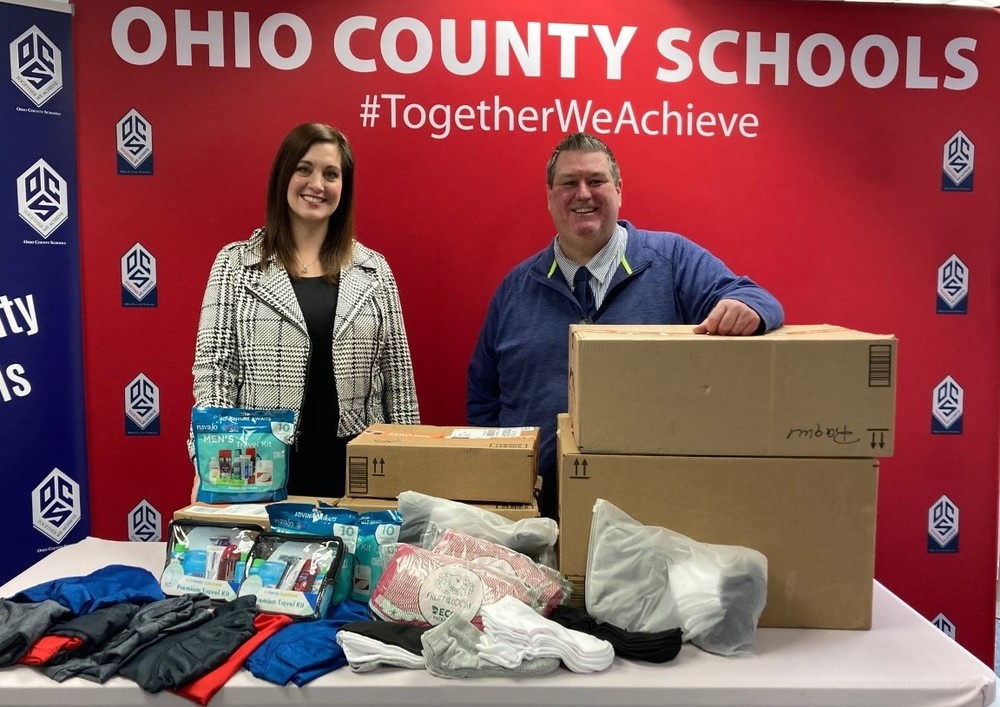 Photo: Ohio County Schools just received donations for students in need as part of a collaboration with the United Way of the Upper Ohio Valley. United Way Executive Director Jessica Rine and Ohio County Schools Communications Coordinator Gabe Wells are shown with just some of those donations.