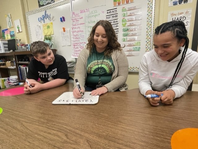 Pictured is Elm Grove Elementary School teacher Alexandria Parker working with two of her students.