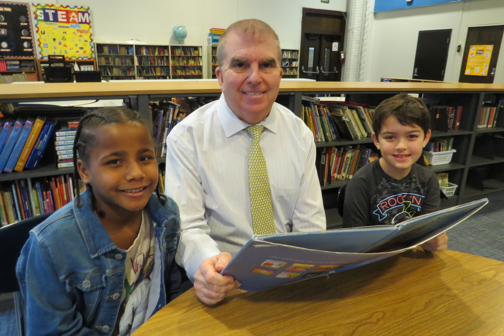 Pictured is Ritchie Elementary School Principal John Jorden reading with fourth-grade students Mya Quinones, at left, and Keiryn O’Connel. Ritchie students are taking part in the school’ s new “Rockin’ Ritchie Readers” program.